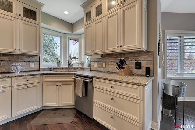 5100 Bridle Ln, Lincoln, NE 68516 - kitchen with stainless steel dishwasher, a sink, dark wood-type flooring, and decorative backsplash