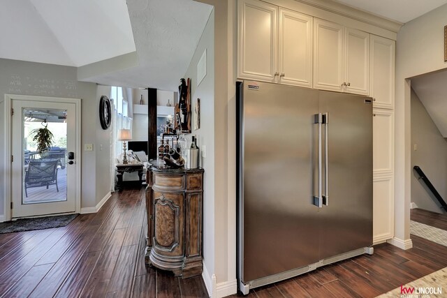 5100 Bridle Ln, Lincoln, NE 68516 - kitchen with high quality fridge, dark wood-style floors, baseboards, and white cabinets