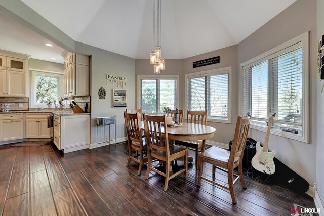 5100 Bridle Ln, Lincoln, NE 68516 - dining area featuring dark wood-style floors, lofted ceiling, baseboards, and recessed lighting