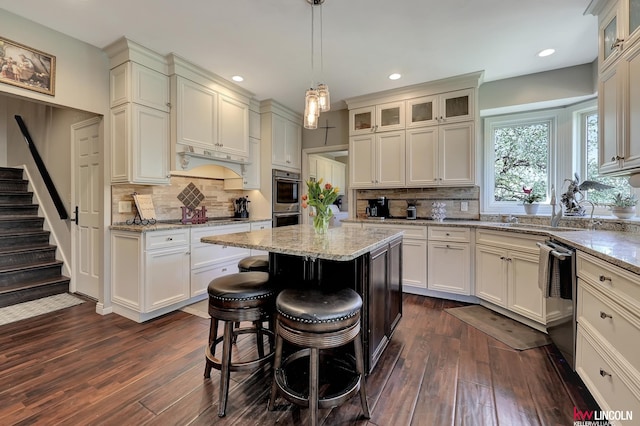 5100 Bridle Ln, Lincoln, NE 68516 - kitchen with appliances with stainless steel finishes, dark wood-style flooring, recessed lighting, glass insert cabinets, and backsplash