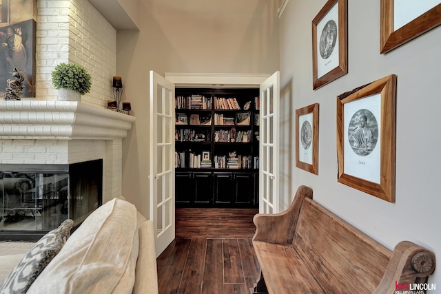 5100 Bridle Ln, Lincoln, NE 68516 - sitting room featuring dark wood-style flooring, a fireplace, and french doors