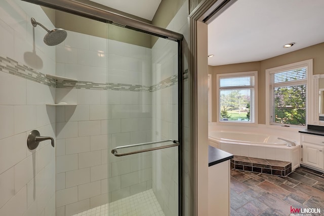 5100 Bridle Ln, Lincoln, NE 68516 - full bath featuring a shower stall, vanity, a garden tub, stone tile floors, and recessed lighting