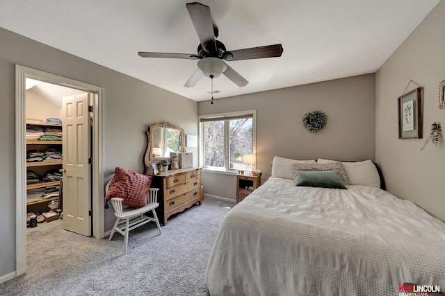 5100 Bridle Ln, Lincoln, NE 68516 - bedroom featuring a walk in closet, light carpet, a closet, ceiling fan, and baseboards