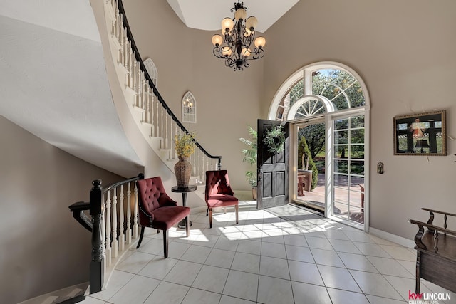 5100 Bridle Ln, Lincoln, NE 68516 - tiled entryway with high vaulted ceiling, stairway, a chandelier, and baseboards
