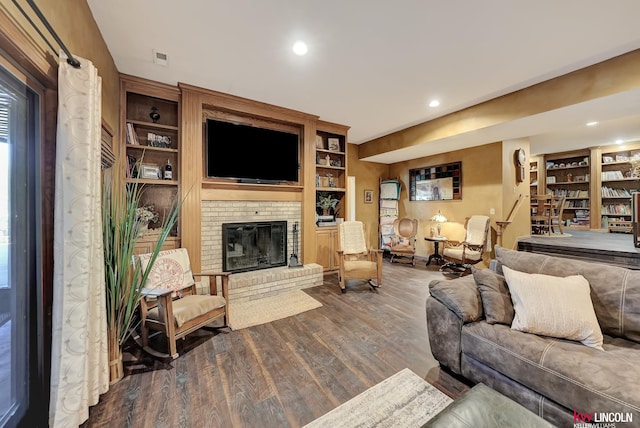 5100 Bridle Ln, Lincoln, NE 68516 - living room featuring wood finished floors, built in features, a brick fireplace, recessed lighting, and baseboards