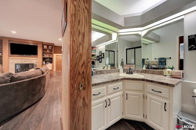 5100 Bridle Ln, Lincoln, NE 68516 - bathroom with vanity, wood finished floors, and a brick fireplace