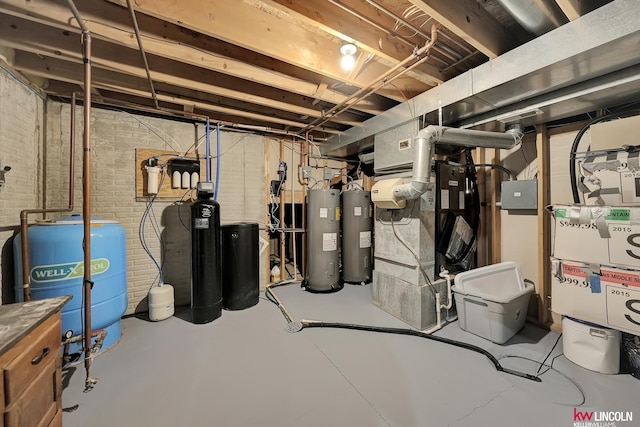 5100 Bridle Ln, Lincoln, NE 68516 - unfinished below grade area featuring electric water heater, a water pressure tank, a water softener, and brick wall