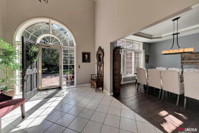 5100 Bridle Ln, Lincoln, NE 68516 - dining space with tile patterned floors, baseboards, and a raised ceiling