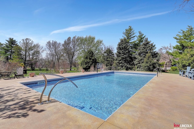 5100 Bridle Ln, Lincoln, NE 68516 - swimming pool featuring a patio and view of scattered trees