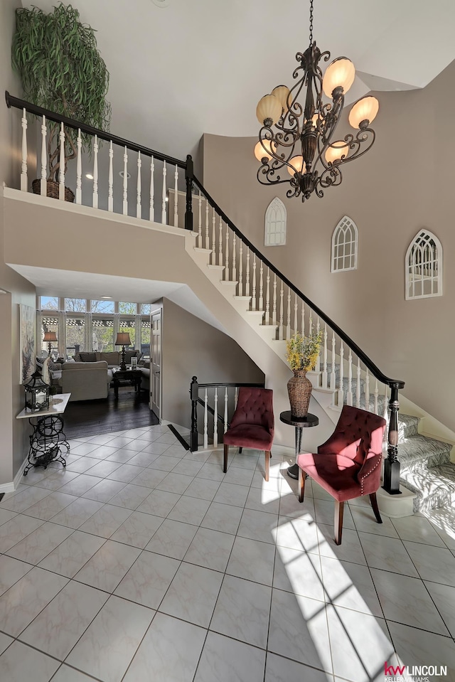 5100 Bridle Ln, Lincoln, NE 68516 - entrance foyer with a towering ceiling, stairs, a chandelier, tile patterned flooring, and baseboards