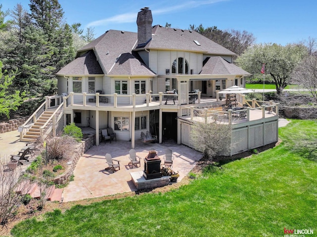 5100 Bridle Ln, Lincoln, NE 68516 - rear view of house with an outdoor fire pit, stairway, a lawn, a patio, and a wooden deck