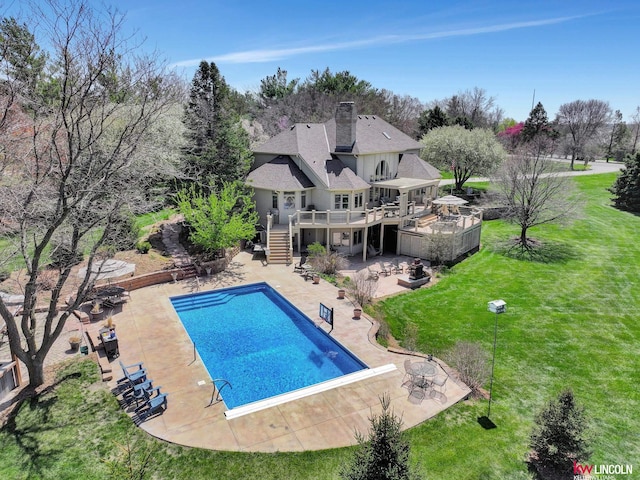 5100 Bridle Ln, Lincoln, NE 68516 - rear view of property with stairs, a wooden deck, a lawn, a patio area, and a chimney