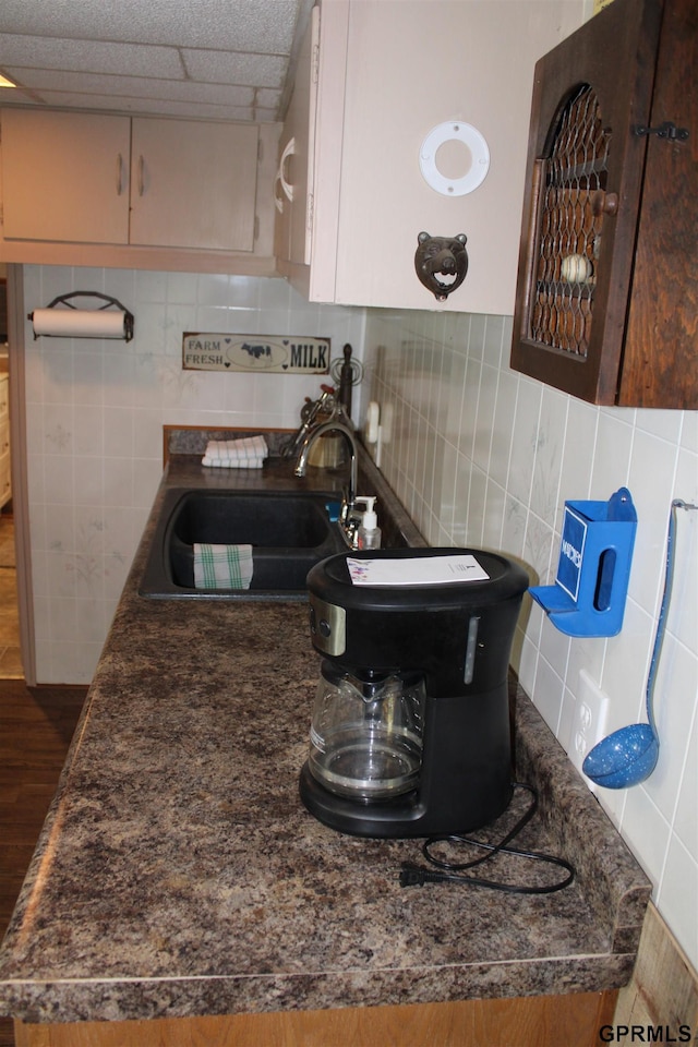 23809 F Plz Unit 9, Waterloo, NE 68069 - kitchen featuring a sink, dark countertops, dark wood-style flooring, tile walls, and backsplash