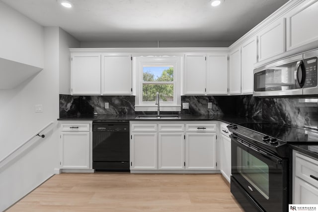 14611 Holmes St, Omaha, NE 68137 - kitchen featuring black appliances, a sink, dark countertops, and recessed lighting