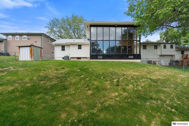 14611 Holmes St, Omaha, NE 68137 - rear view of house with central AC and a sunroom