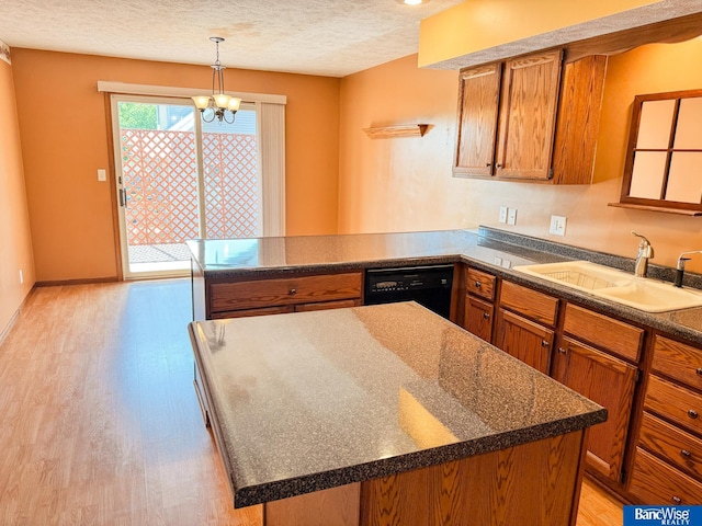 1881 Meadow Ln, Seward, NE 68434 - kitchen with dishwasher, a sink, brown cabinets, a peninsula, and light wood-type flooring