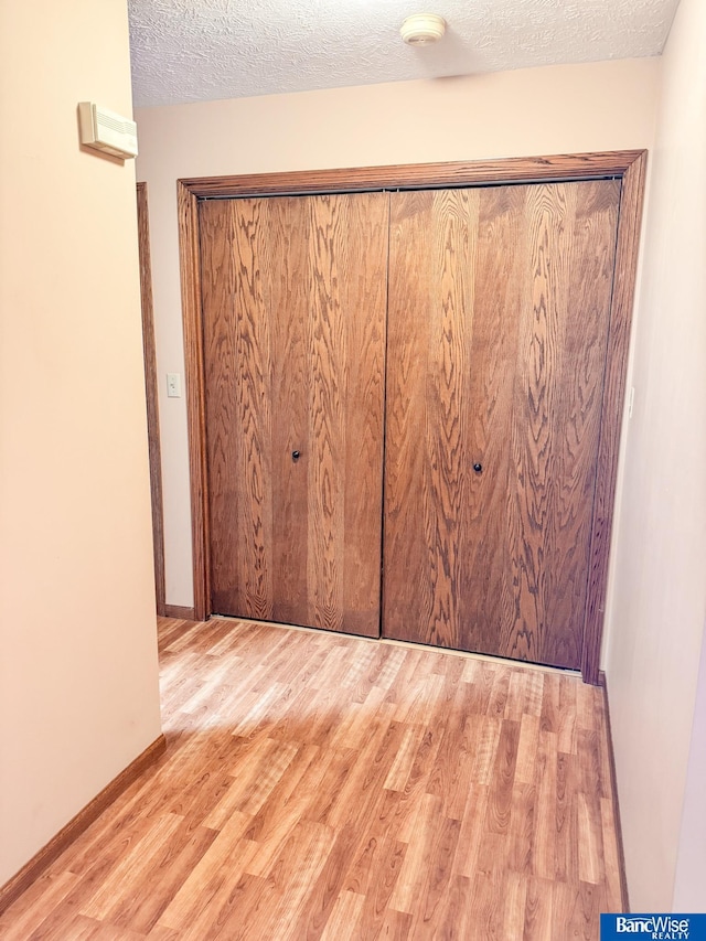 1881 Meadow Ln, Seward, NE 68434 - unfurnished bedroom featuring wood finished floors, a textured ceiling, and baseboards
