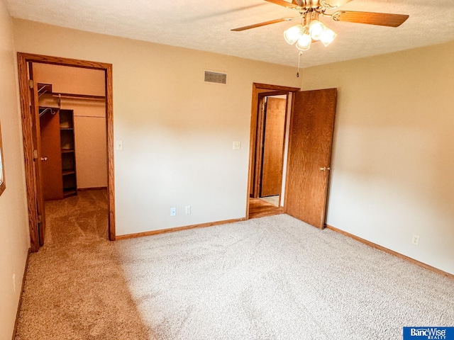 1881 Meadow Ln, Seward, NE 68434 - unfurnished bedroom featuring a spacious closet, carpet floors, a closet, baseboards, and a ceiling fan