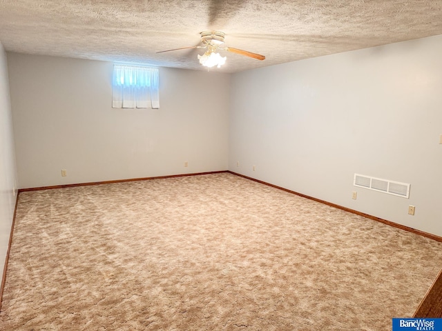 1881 Meadow Ln, Seward, NE 68434 - unfurnished room with a textured ceiling, carpet flooring, ceiling fan, and baseboards