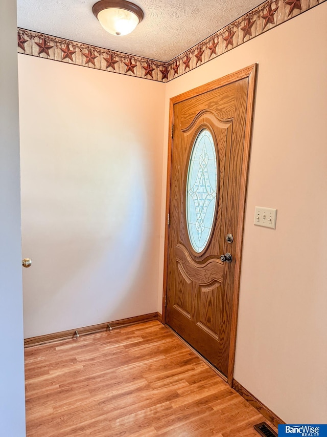 1881 Meadow Ln, Seward, NE 68434 - entrance foyer featuring a textured ceiling, light wood-style flooring, and baseboards