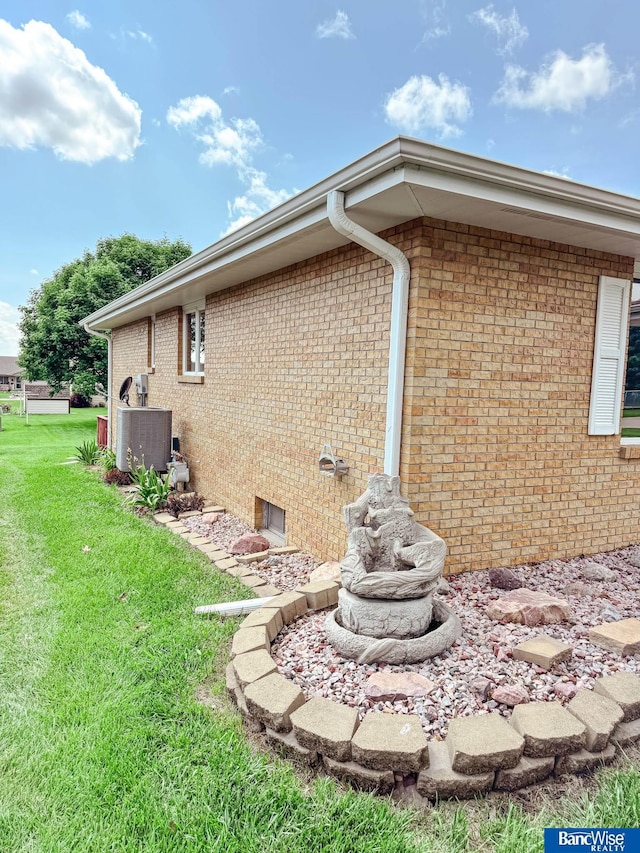 1881 Meadow Ln, Seward, NE 68434 - view of side of home with a lawn, brick siding, and cooling unit
