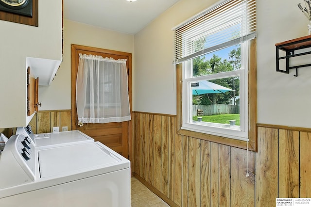 8345 Burt St, Omaha, NE 68114 - washroom featuring wooden walls, washer and dryer, and wainscoting