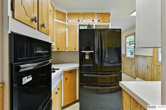8345 Burt St, Omaha, NE 68114 - kitchen with black appliances, light countertops, wainscoting, and wood walls