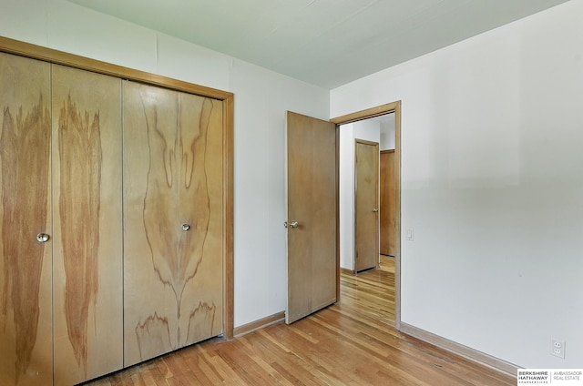 8345 Burt St, Omaha, NE 68114 - unfurnished bedroom with light wood-style floors and a closet