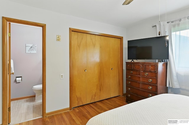 8345 Burt St, Omaha, NE 68114 - bedroom with wood finished floors, a closet, and ensuite bath