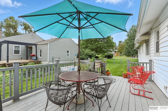 8345 Burt St, Omaha, NE 68114 - wooden terrace with outdoor dining space and a yard