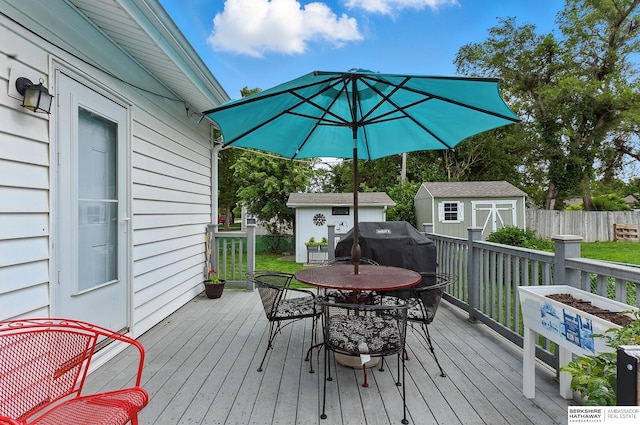 8345 Burt St, Omaha, NE 68114 - wooden terrace featuring a storage unit, outdoor dining area, and area for grilling