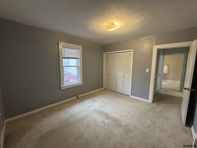 6035 Woolworth Ave, Omaha, NE 68106 - unfurnished bedroom featuring a closet, carpet floors, a textured ceiling, and baseboards