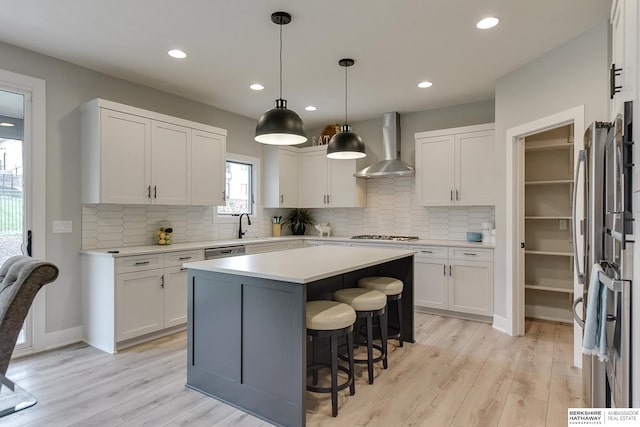 5807 N Hws Cleveland Blvd, Omaha, NE 68116 - kitchen featuring wall chimney exhaust hood, light wood finished floors, white cabinetry, light countertops, and recessed lighting