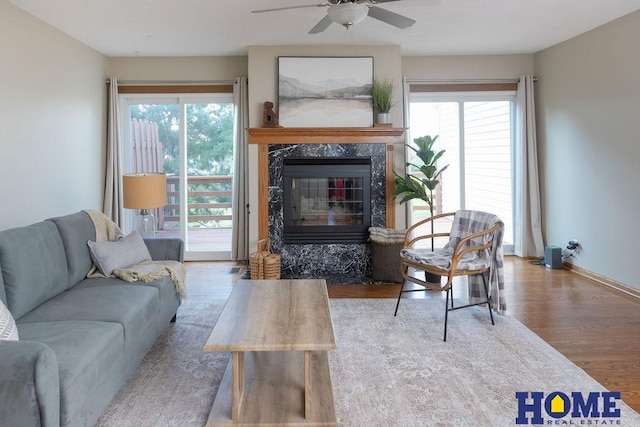 6207 Benjamin Pl, Lincoln, NE 68516 - living room with wood finished floors, ceiling fan, a fireplace, and baseboards