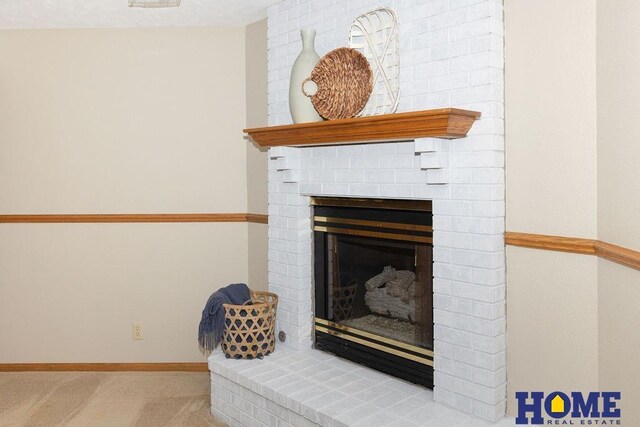 6207 Benjamin Pl, Lincoln, NE 68516 - detailed view of carpet floors, a brick fireplace, and baseboards
