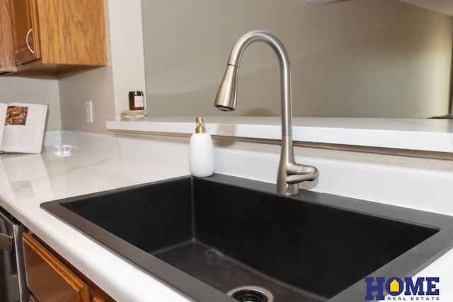 6207 Benjamin Pl, Lincoln, NE 68516 - kitchen view of a sink, brown cabinets, and light countertops