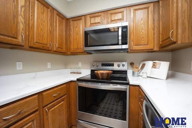 6207 Benjamin Pl, Lincoln, NE 68516 - kitchen with stainless steel appliances, brown cabinetry, and light countertops