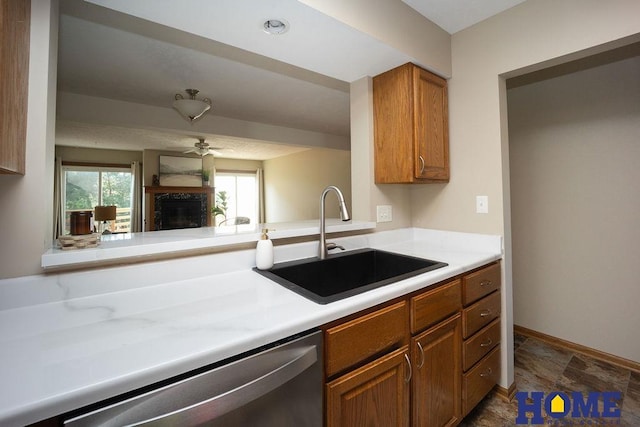 6207 Benjamin Pl, Lincoln, NE 68516 - kitchen with dishwasher, a sink, brown cabinets, light countertops, and a ceiling fan