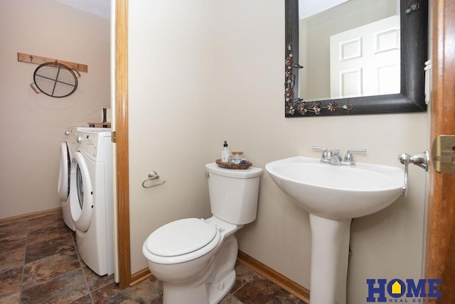 6207 Benjamin Pl, Lincoln, NE 68516 - bathroom featuring toilet, stone finish flooring, independent washer and dryer, and baseboards