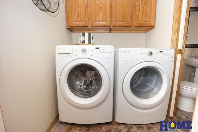 6207 Benjamin Pl, Lincoln, NE 68516 - laundry area featuring washer and dryer, cabinet space, and stone finish floors