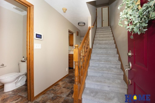 6207 Benjamin Pl, Lincoln, NE 68516 - staircase featuring stone finish floors and baseboards
