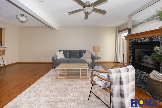 6207 Benjamin Pl, Lincoln, NE 68516 - living area featuring a ceiling fan, baseboards, wood finished floors, a high end fireplace, and beamed ceiling