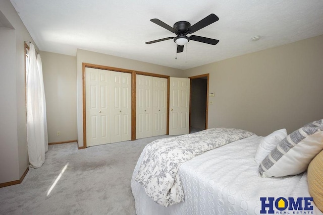 6207 Benjamin Pl, Lincoln, NE 68516 - bedroom with two closets, light colored carpet, baseboards, and ceiling fan