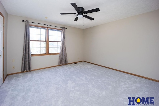 6207 Benjamin Pl, Lincoln, NE 68516 - empty room featuring light carpet, baseboards, and a ceiling fan