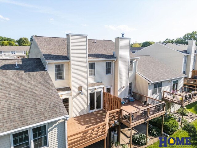 6207 Benjamin Pl, Lincoln, NE 68516 - rear view of house with a wooden deck, a chimney, and roof with shingles