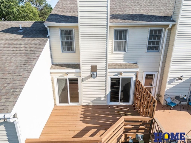 6207 Benjamin Pl, Lincoln, NE 68516 - back of property featuring a deck, a shingled roof, and a chimney