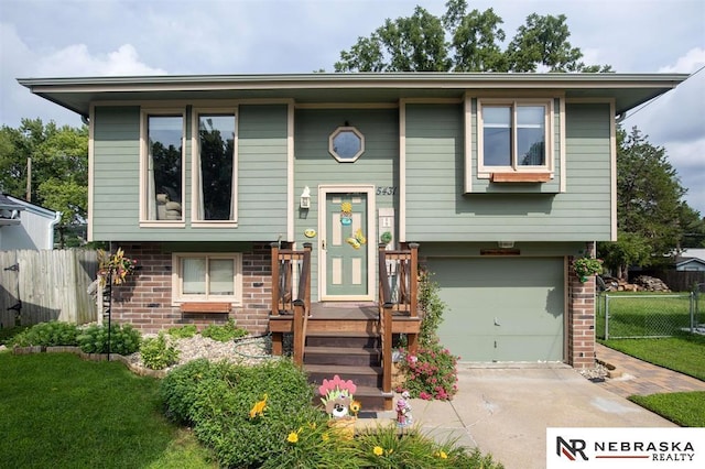 5431 S 48th Ave, Omaha, NE 68117 - raised ranch with brick siding, an attached garage, and concrete driveway