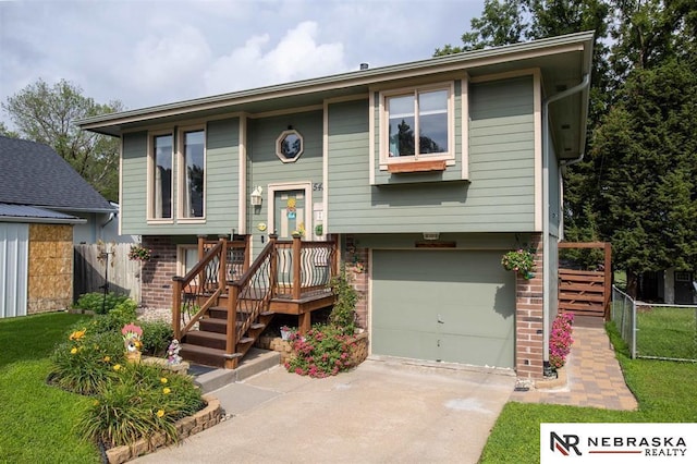 5431 S 48th Ave, Omaha, NE 68117 - bi-level home with a garage, brick siding, and concrete driveway