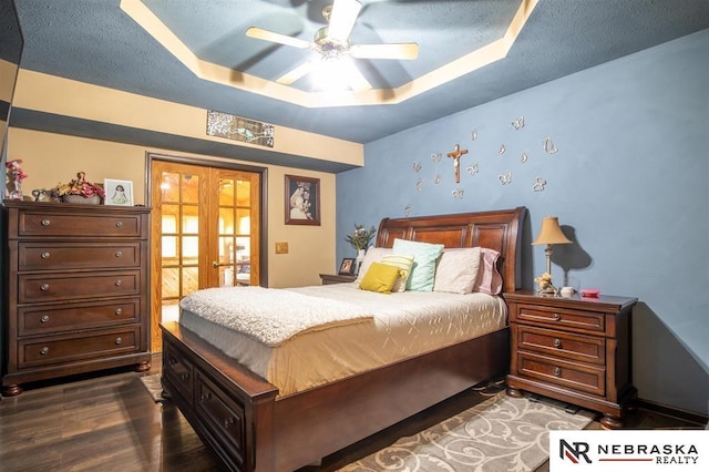 5431 S 48th Ave, Omaha, NE 68117 - bedroom featuring french doors, a tray ceiling, dark wood-type flooring, and ceiling fan