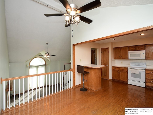 15211 Pasadena Ave, Omaha, NE 68144 - kitchen featuring white appliances, ceiling fan, dark wood-type flooring, brown cabinetry, and light countertops